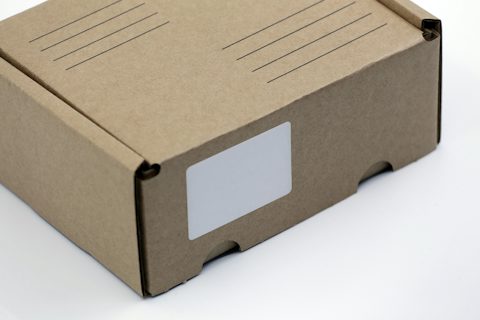 Damaged cardboard parcel on a counter